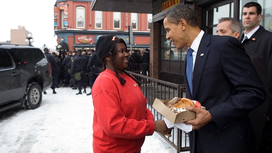 President Barack Obama being presented with a "Beaver Tail" pastry in the Byward Market, Ottawa, Canada.