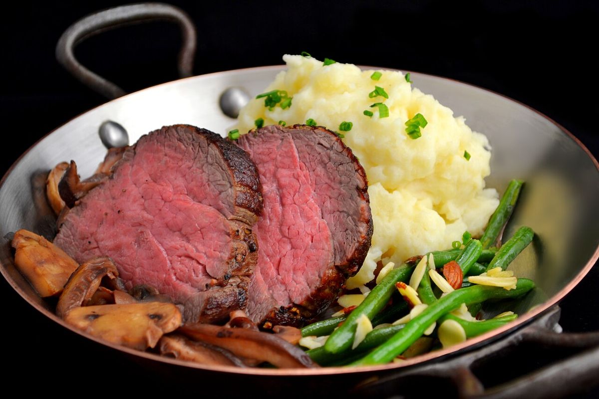 Filet of beef: a dish with whipped potatoes, a mixture of mushroom varieties, and green beans amandine.