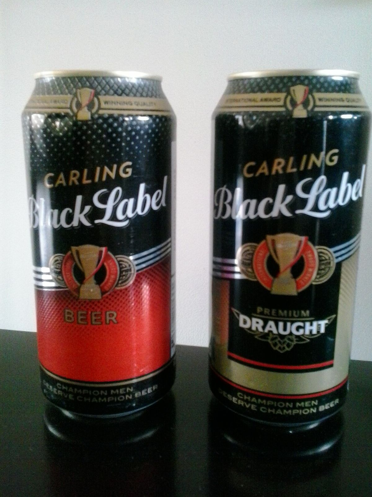 A photograph of two varieties of Carling Black Label Beer cans