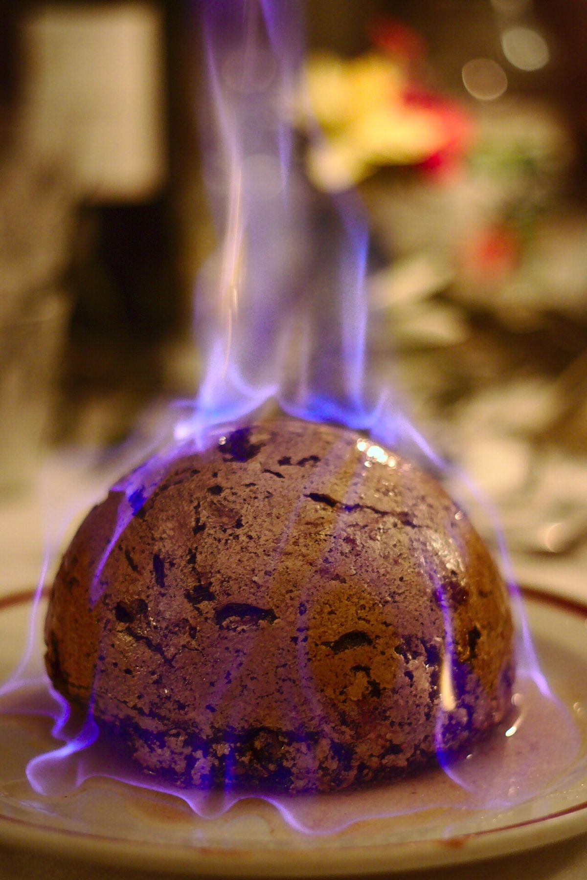 A Christmas pudding being flamed