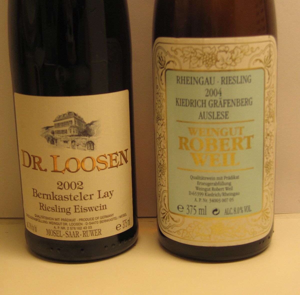 Wine bottles from Dr. Loosen (Mosel) and Robert Weil (Rheingau) showing typical German wine labels