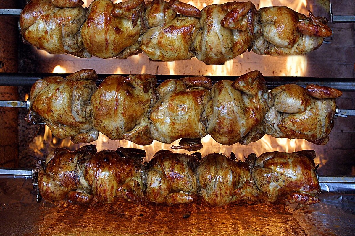 Chickens cooking on rotisserie at Chicks Natural restaurant