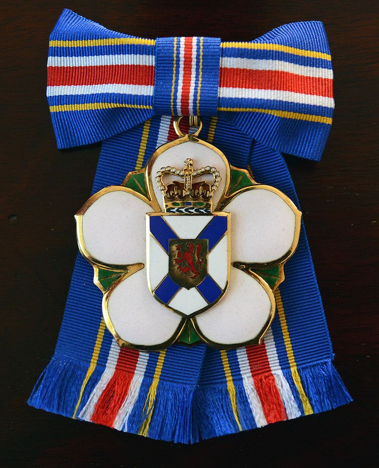 Insignia of the Order of Nova Scotia, mounted on a bow. Multipiece sterling silver, gold plated and enamel order insignia