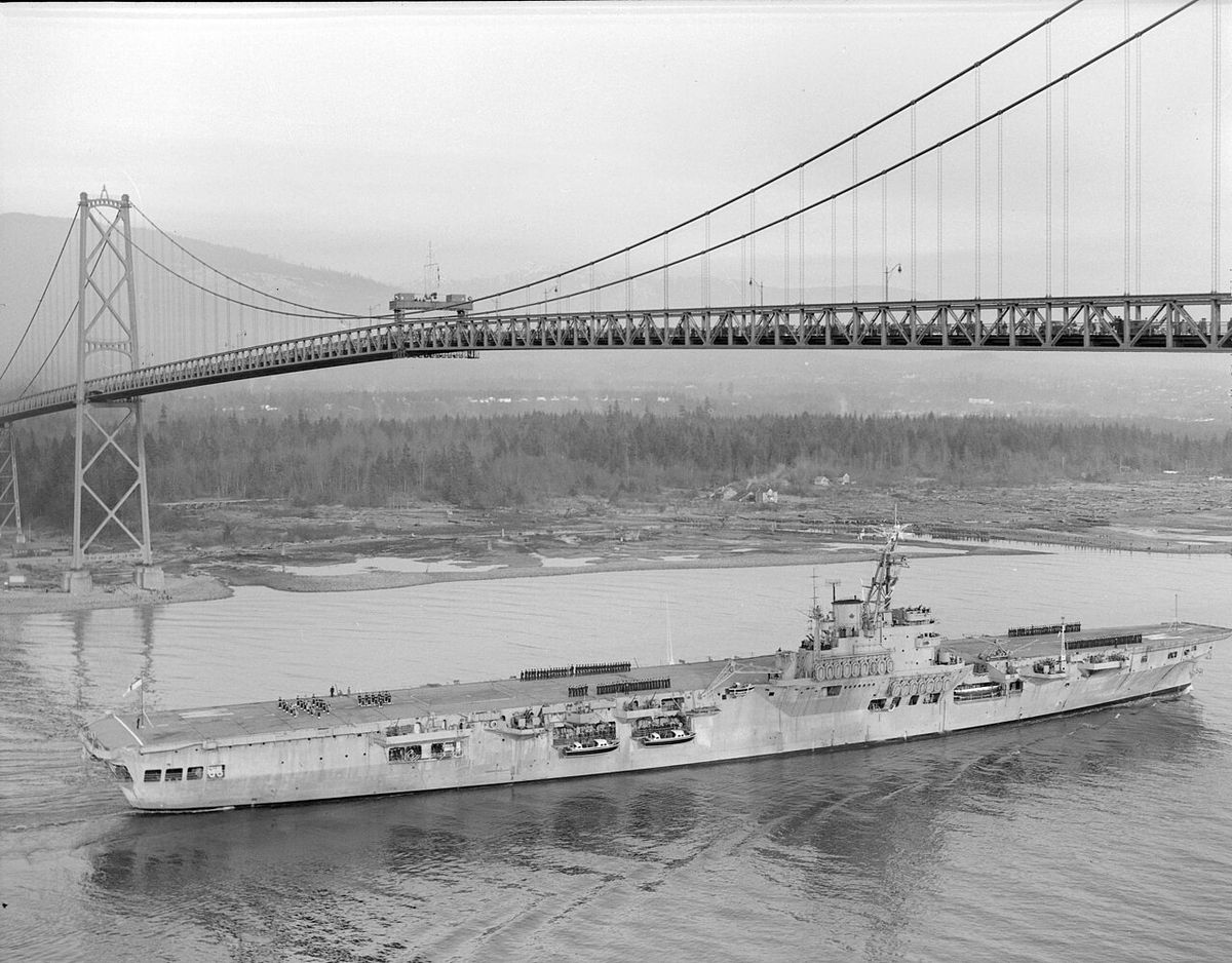 Original caption: H.M.C.S. Warrior passing under the Lions' Gate Bridge